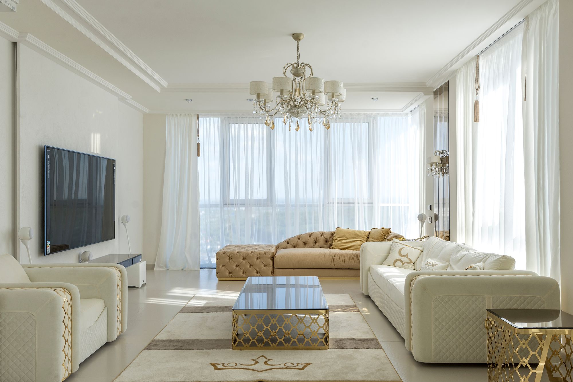 A light-filled luxury living room with floor-to-ceiling city views