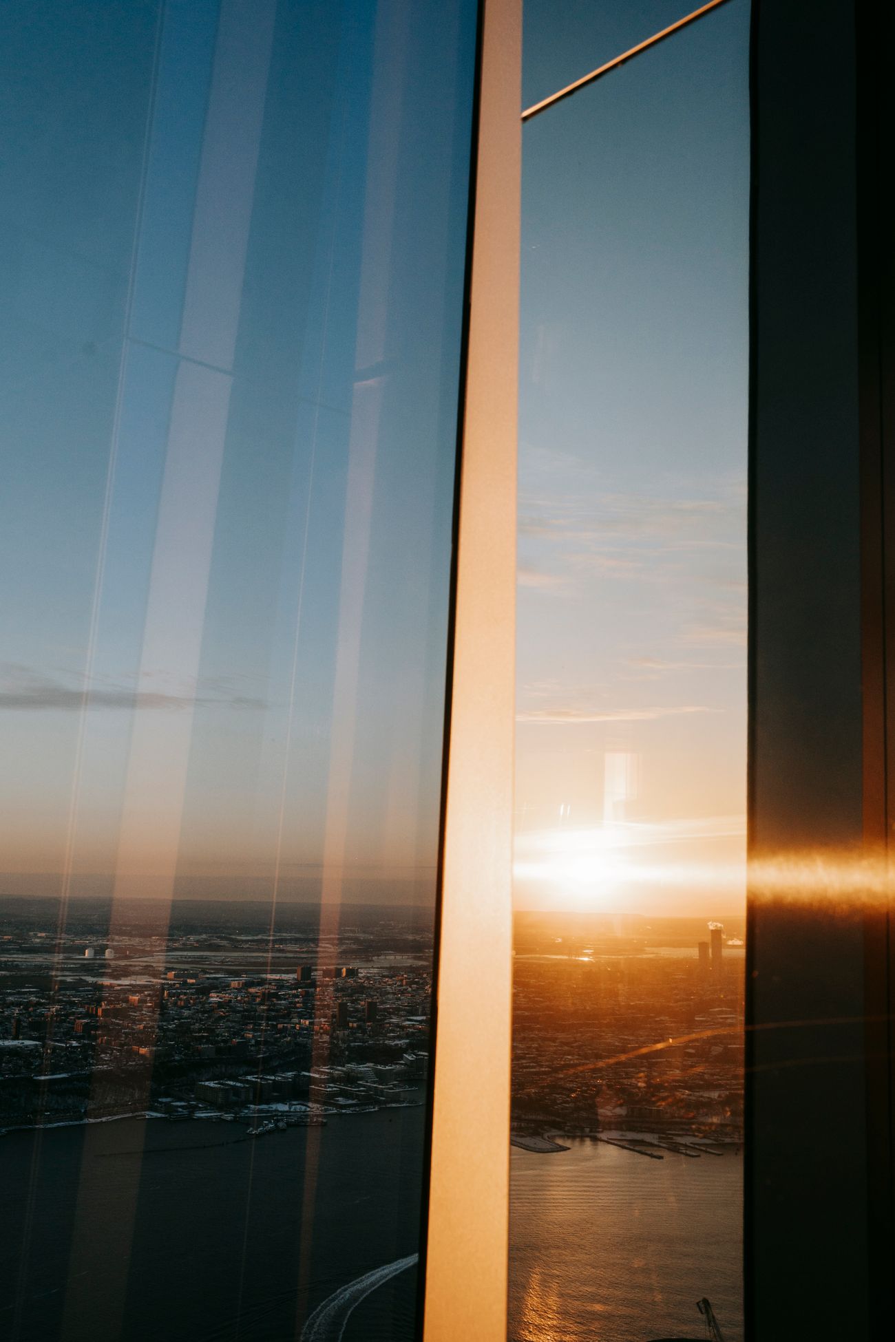 Golden-hour city view through floor-to-ceiling windows